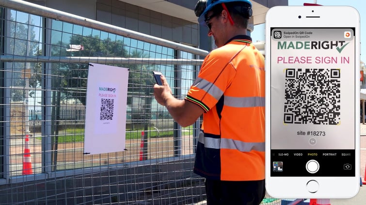 Tradesman scanning QR code on fence