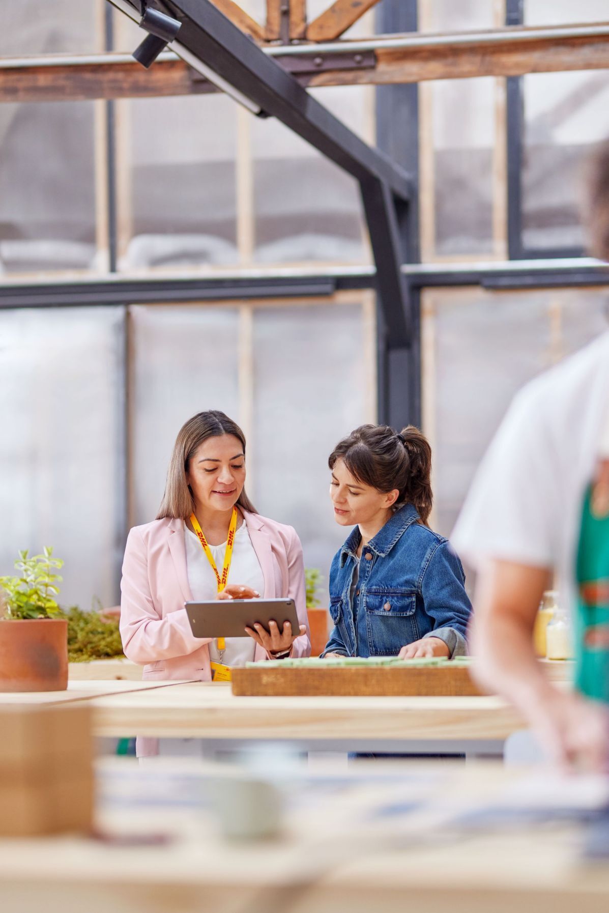 dhl-employee-showing-tablet-to-startup-owner